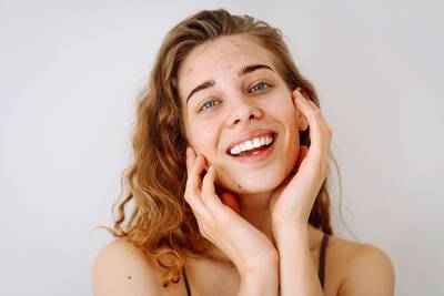 Mulher sorridente com a pele sensivel