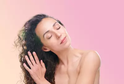 Mulher passando leave-in em seu cabelo
